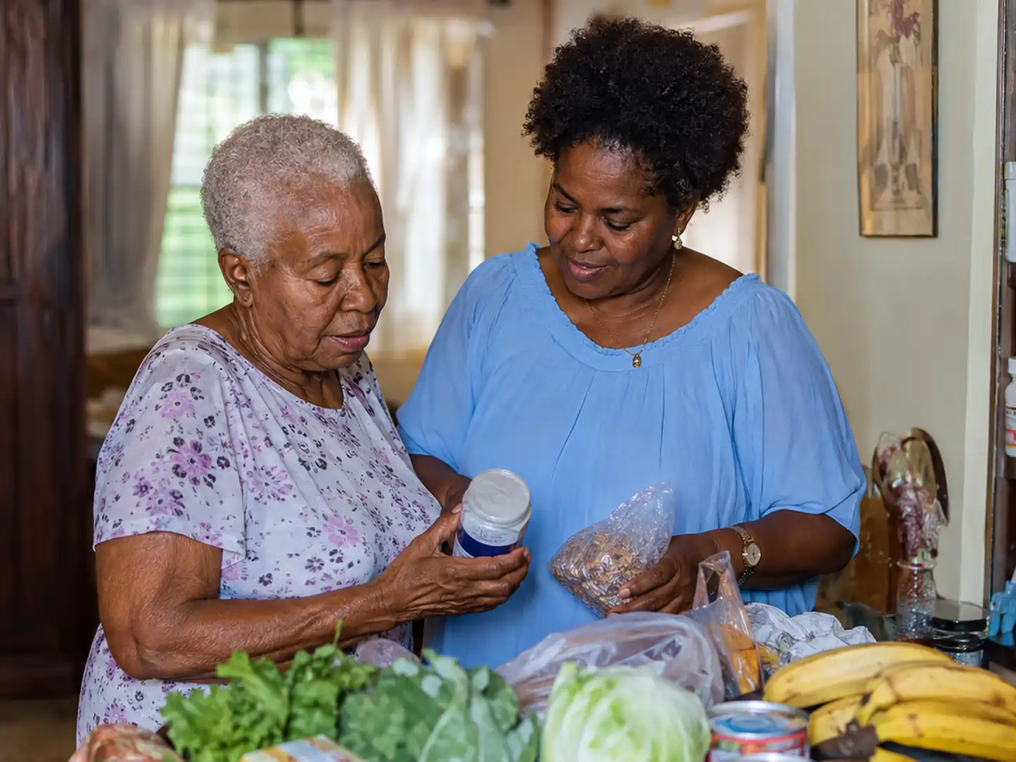 Older Jamaican adult at home with a trusted visitor checking everyday household needs