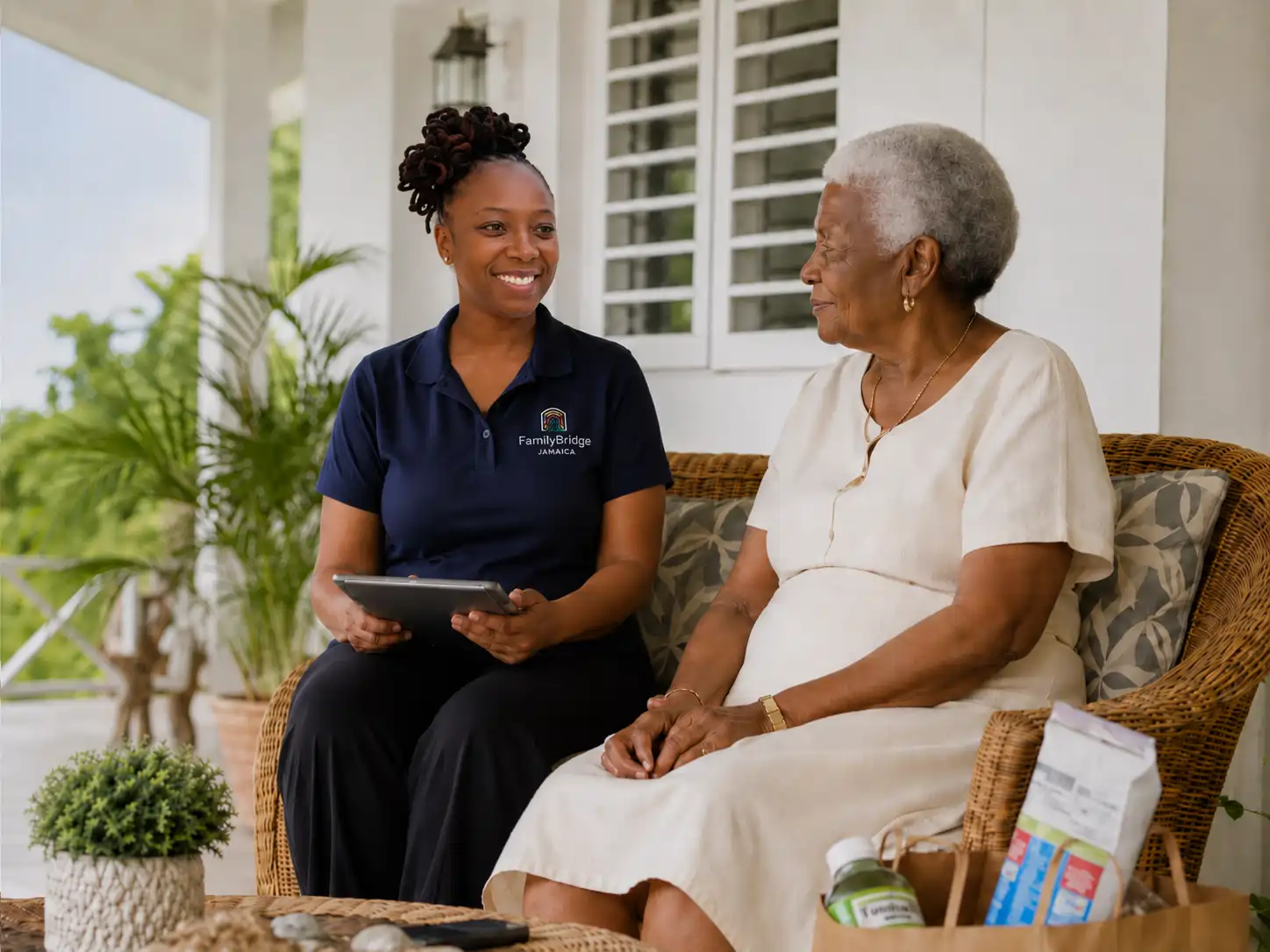 Family Bridge Jamaica representative speaking with an older woman during a home visit